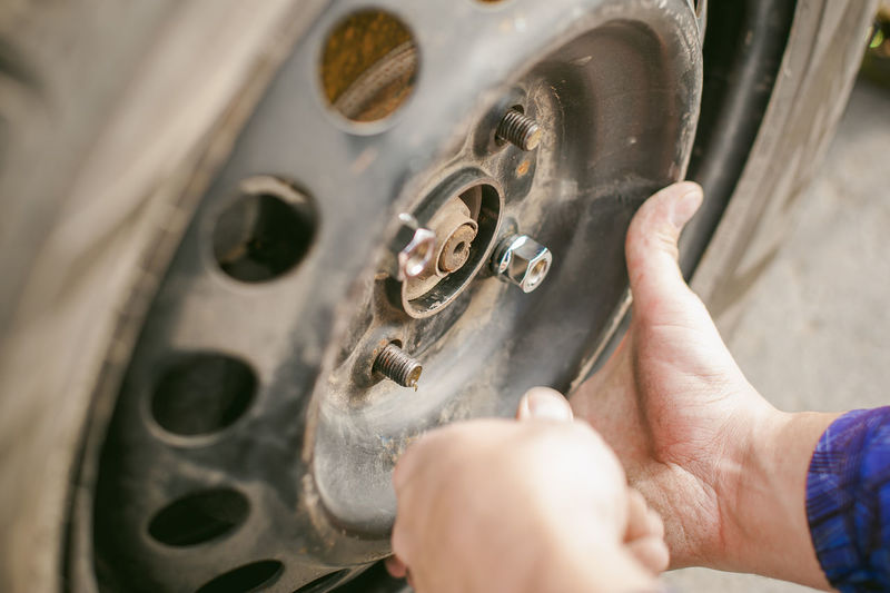Cropped image of mechanic inflating car tire