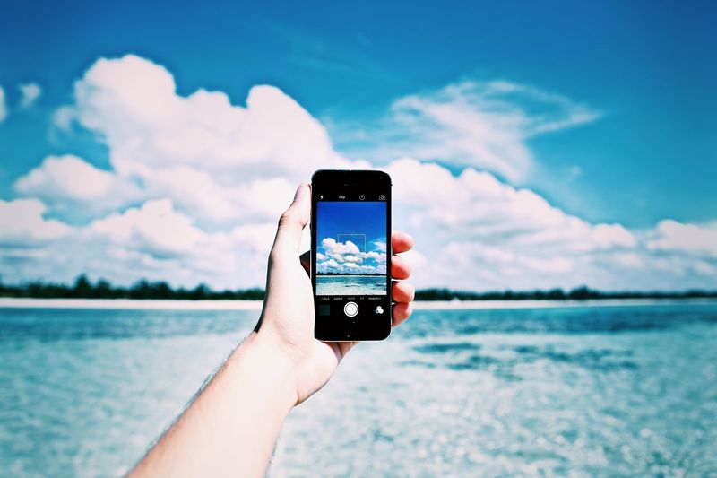 Cropped image of hand holding sea
