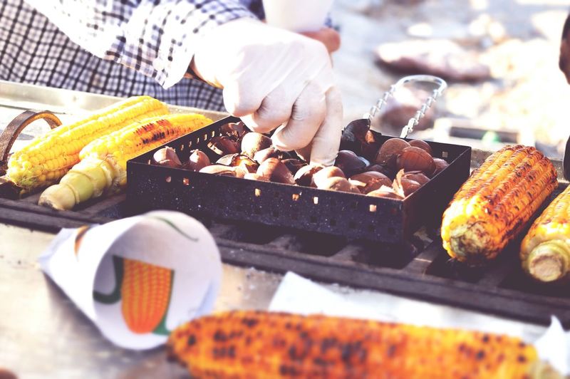 Close-up of man preparing food in grill