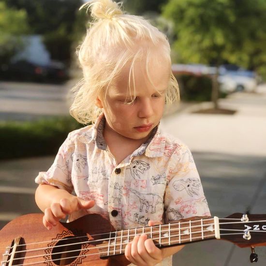 Cute girl playing guitar