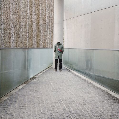 Full length of woman walking on sidewalk