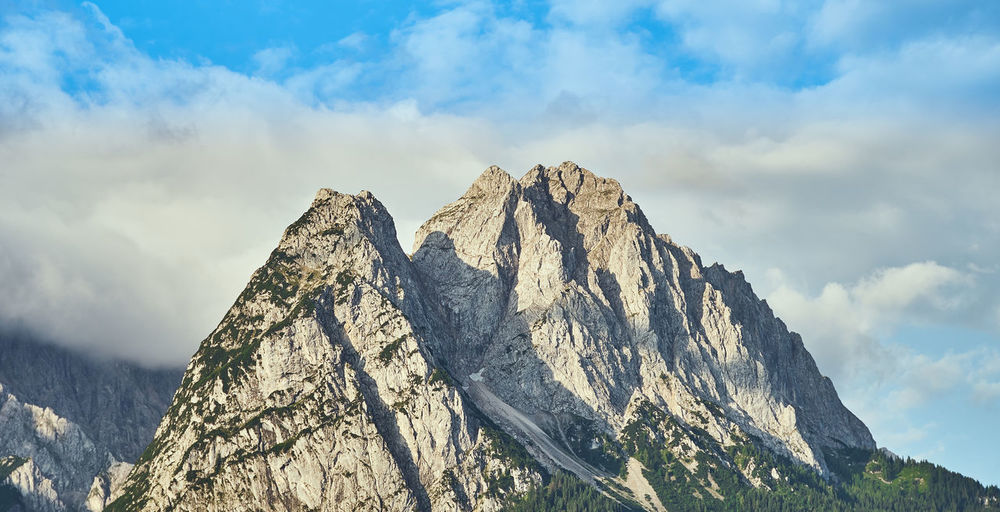 Low angle view of snowcapped mountain against sky