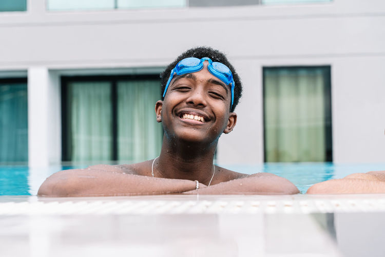 Portrait of smiling young man in swimming pool