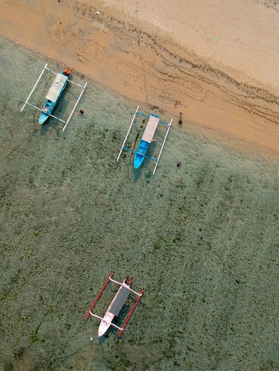 Aerial view of boats moored in sea at beach