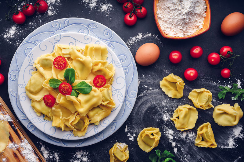 Italian pasta with ingredients and black background. gastronomic concept