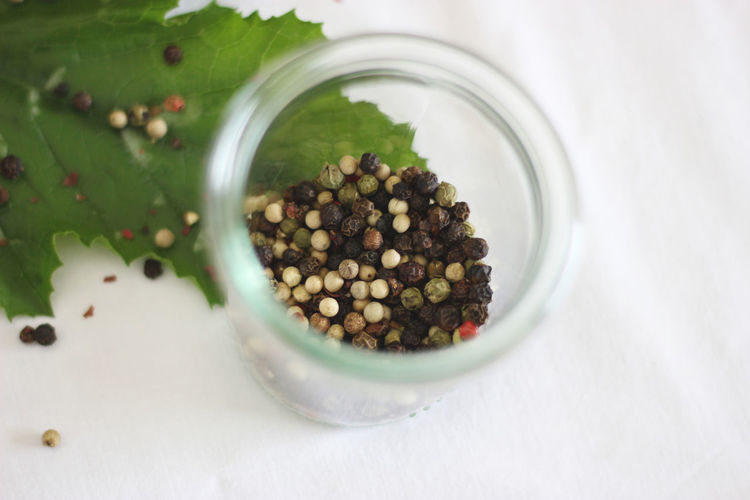 High angle view of peppercorns in jar