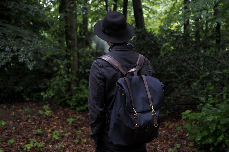 Rear view of a woman standing in forest