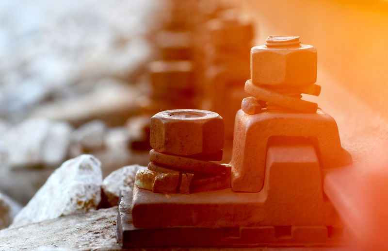 Close-up of nuts and bolts attached to railroad track