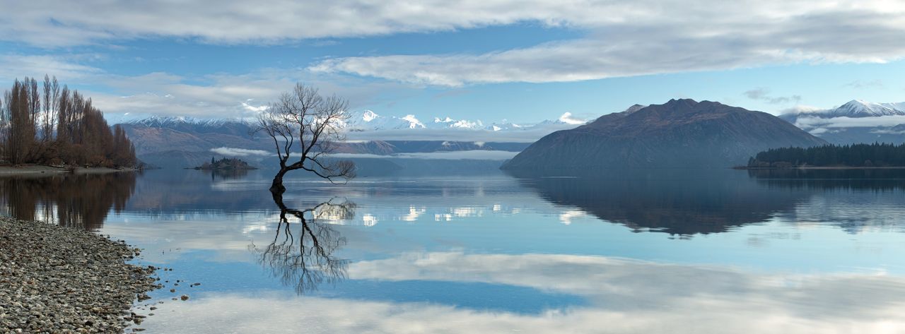 Scenic view of lake and mountains against sky