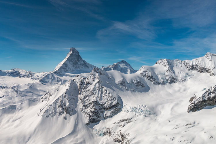 Aerial view of majestic and world famous matterhorn mountain in front of a blue sky, switzerland