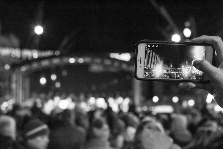 Reflection of people on illuminated street light at night