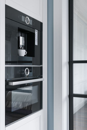 Black built-in appliances, oven and coffee maker