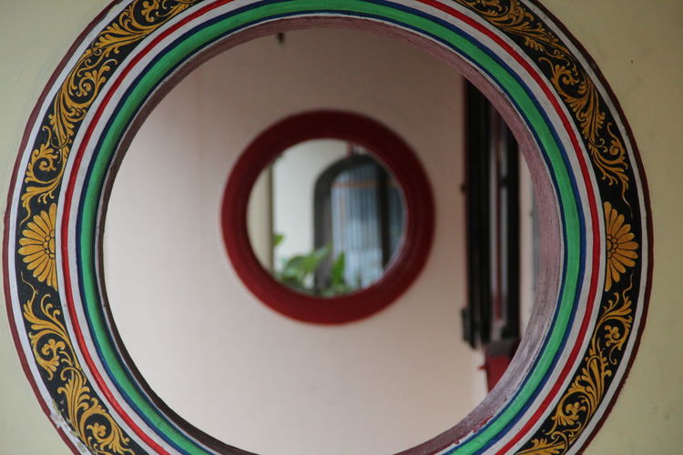 Close-up of mirror mounted on wall