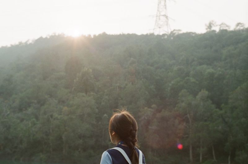 Rear view of woman looking at farm 