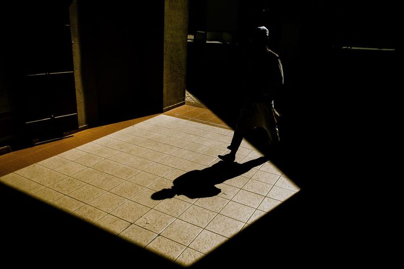 Man shadow on floor during sunny day