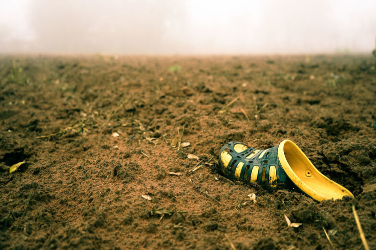 Yellow one shoe on ground atmosphere