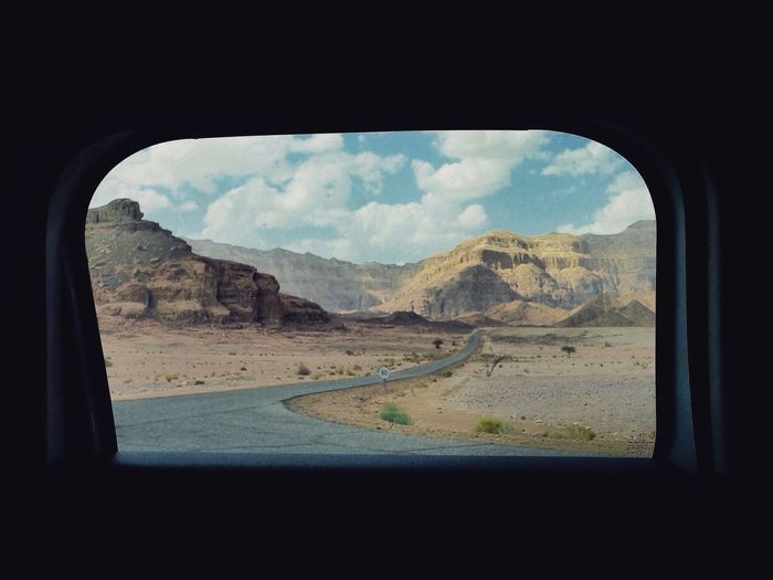 Scenic view of landscape seen through car window