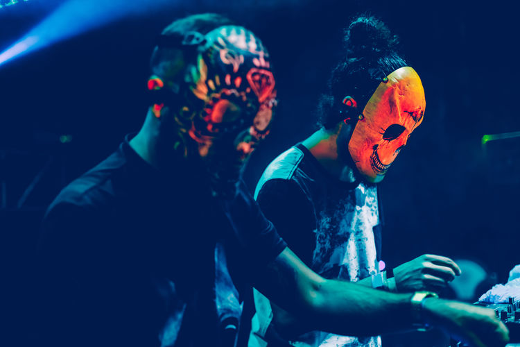 People wearing mask playing music