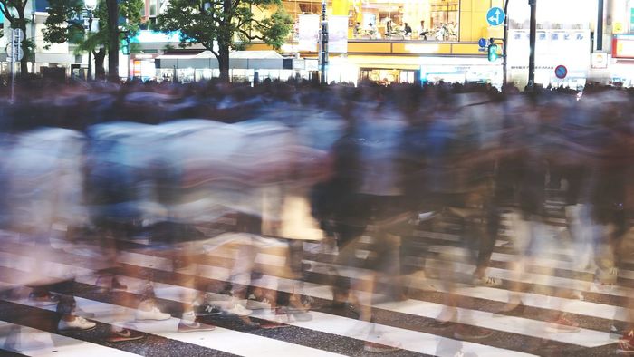 Blurred crowd on zebra crossing during rush hour