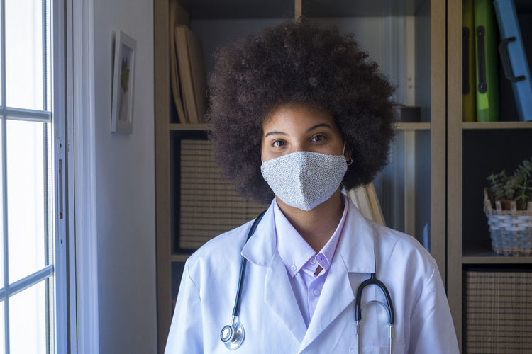 Portrait of doctor wearing flu mask at hospital