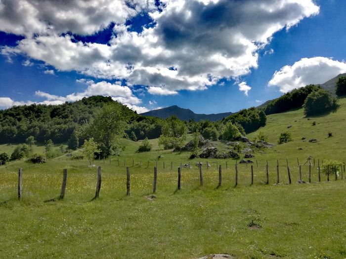 Scenic view of mountains against cloudy sky