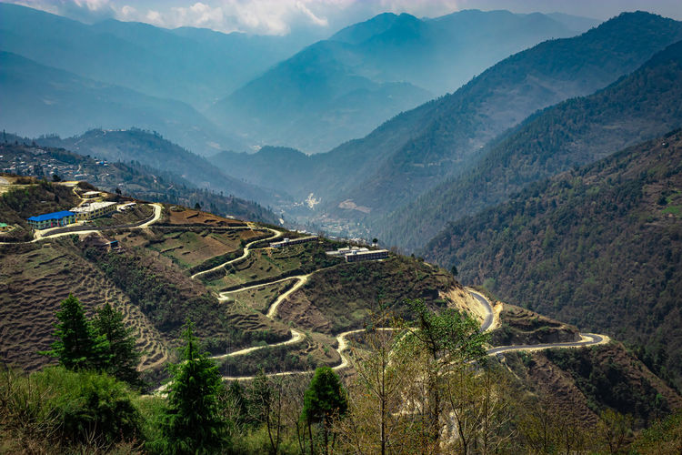 Mountain valley with mountain curvy road and bright blue sky at morning form flat angle
