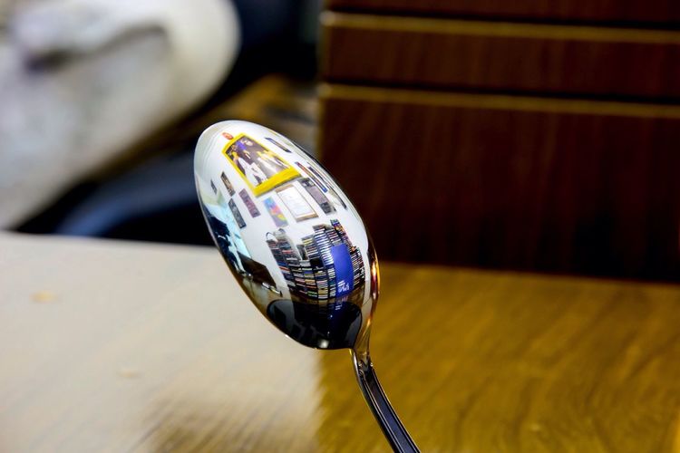Reflection of books on spoon
