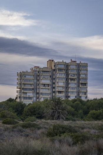 Building emerging from the vegetation at sunset
