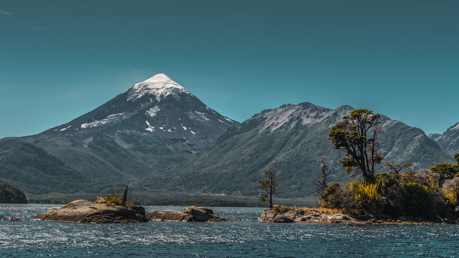 Scenic view of snowcapped mountains against clear blue sky