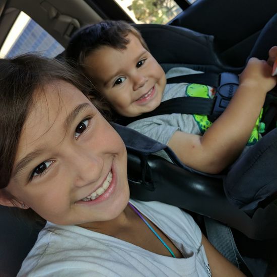 Portrait of smiling boys and girls in car