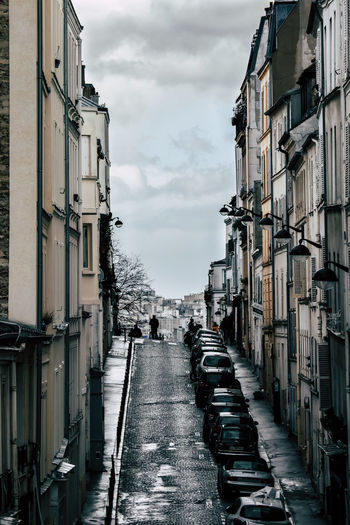 Street amidst buildings against sky in paris