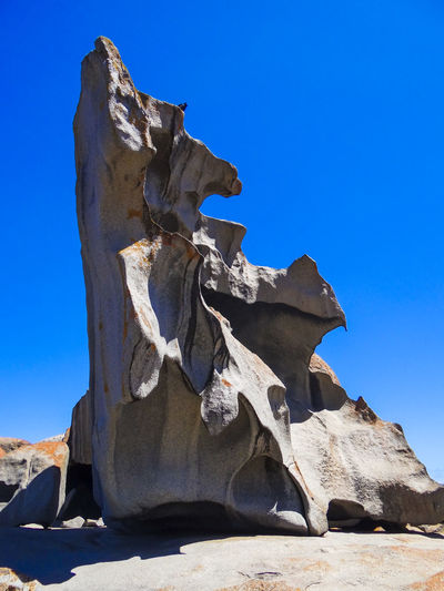 Low angle view of rock formation against blue sky