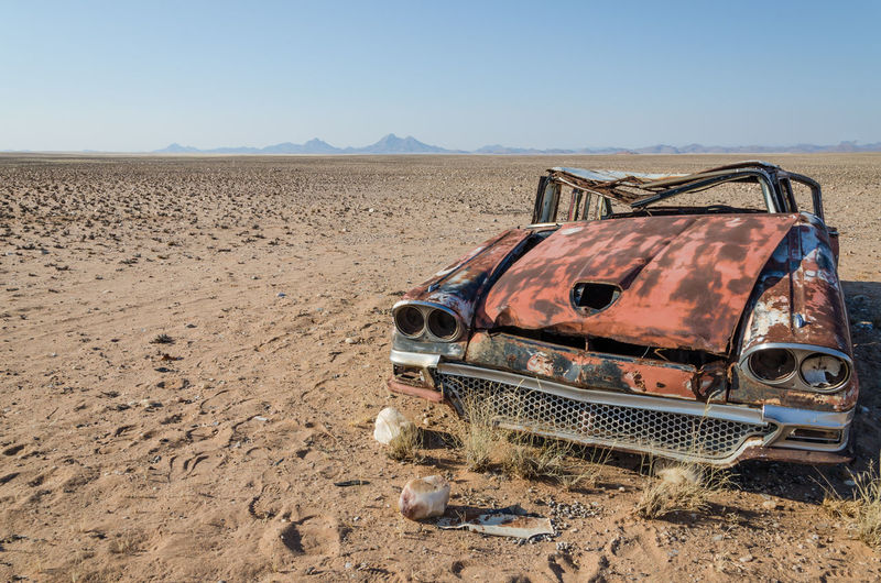 Wreck of abandoned vintage car in namib desert of angola, africa