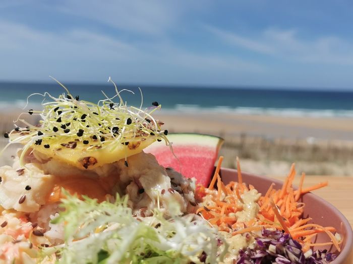 Close-up of food in sea against sky