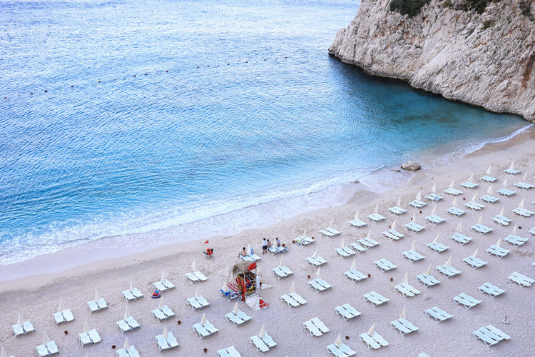 High angle view of deck chairs arranged at beach