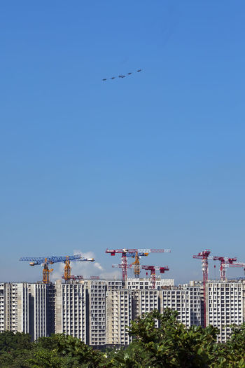 Low angle view of airplane flying against clear blue sky