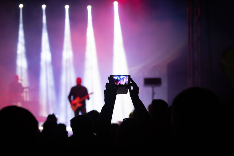 People photographing at music concert
