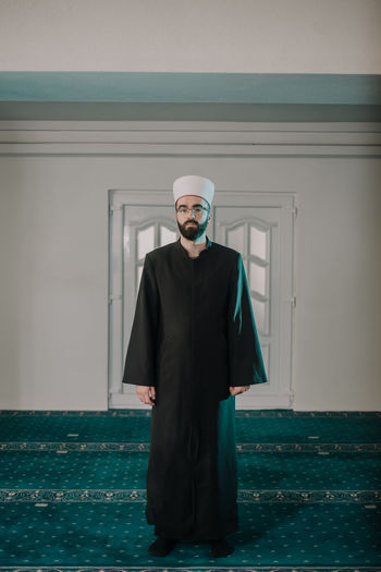Portrait of man standing in mosque