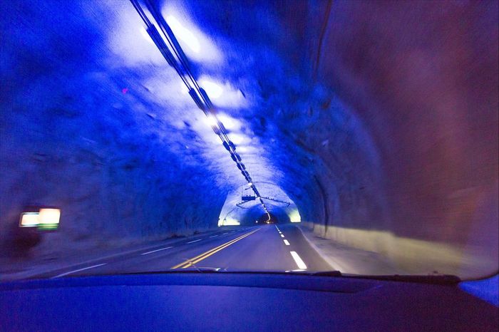 View of tunnel seen from windshield of car