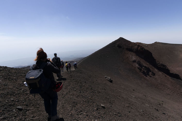 View of tourists walking the mount etna