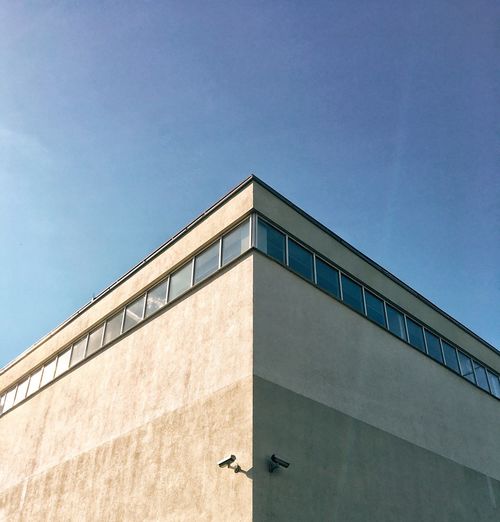 Low angle view of building against clear blue sky