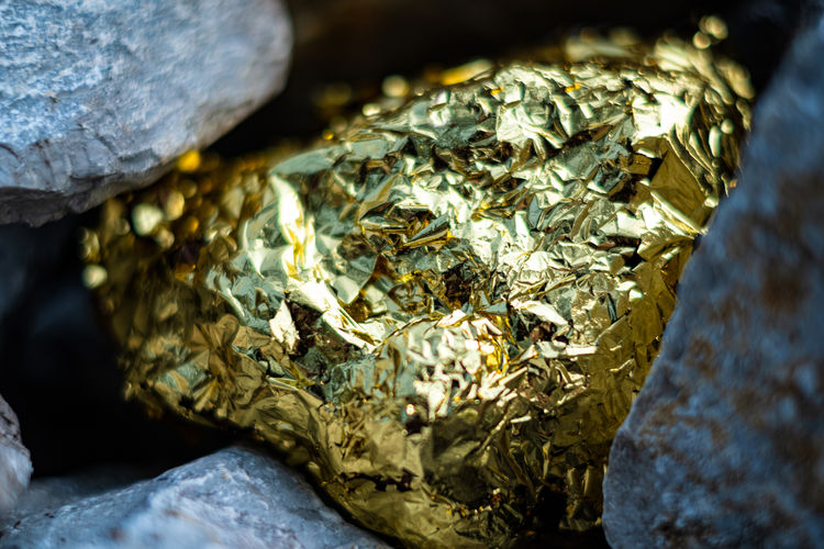 Gold nugget and grey granite stone background