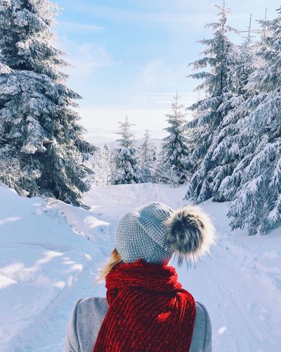 Rear view of woman on snow covered field