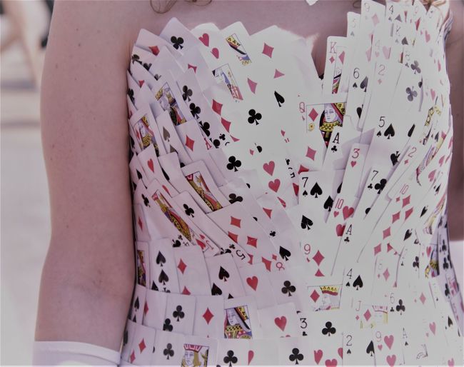 Midsection of woman wearing dress made with playing cards