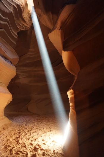 Sunlight streaming through rock formations at antelope canyon