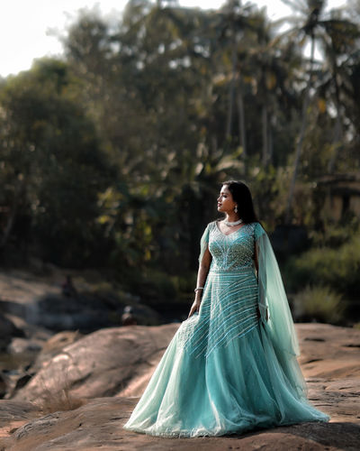 Young woman standing on rock
