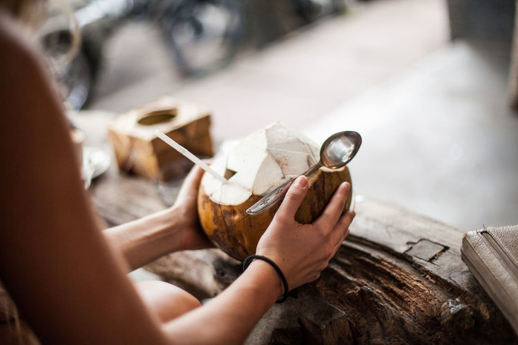 Woman holding coconut drink