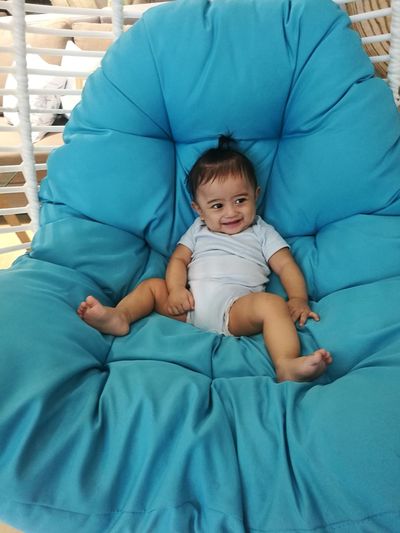 Cute baby relaxing on mattress at home