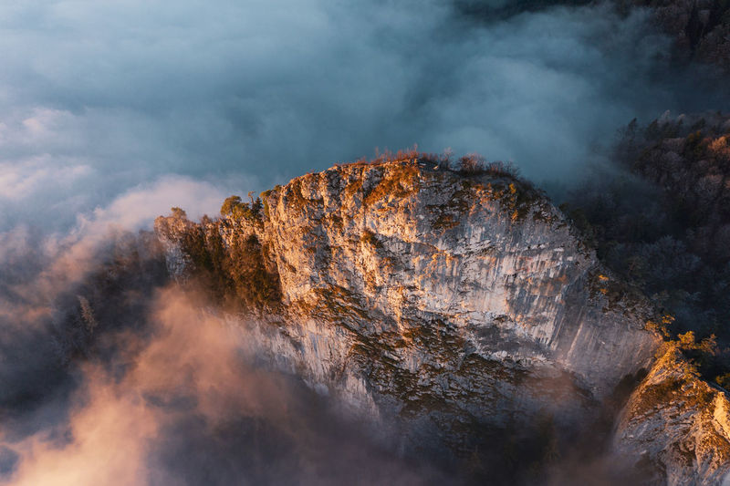 High angle view of mountain ridge rising above the clouds, hallein, austria.