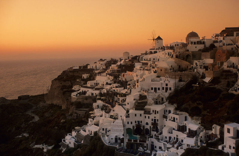 Amazing sunset with the famous wind mill of oia in santorini
